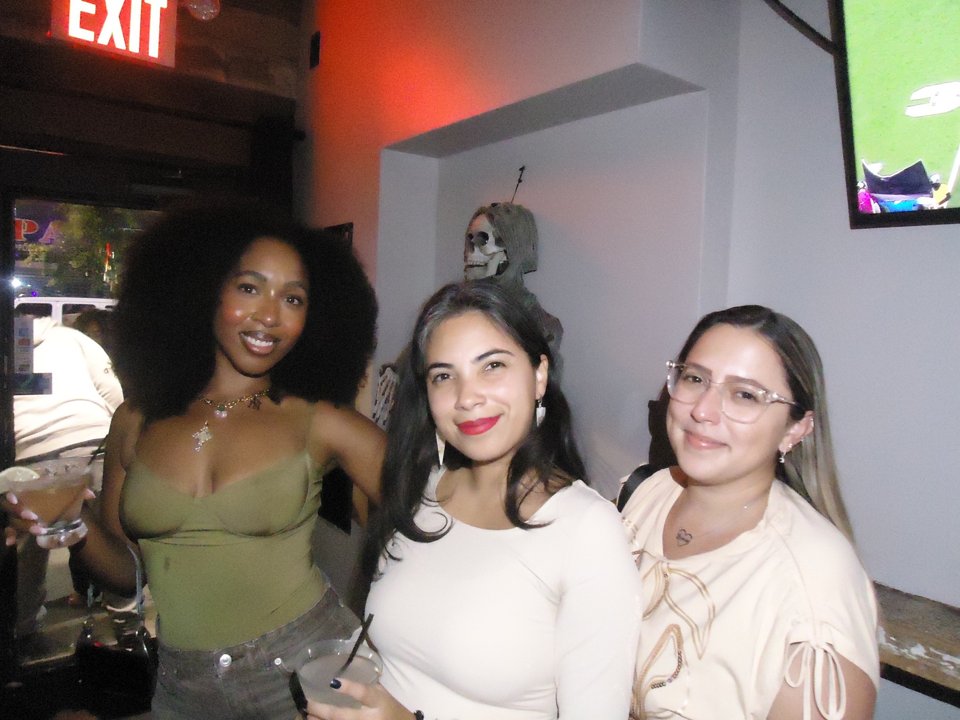 Three From Queens, With Love members smiling side by side during an indoor meetup.